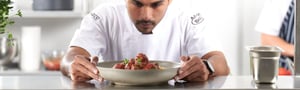 Chef examining plate of Angel Bay meatballs