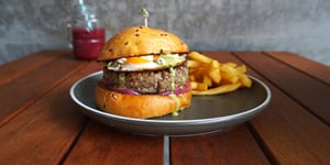 Angel Bay beef burger with egg on a plate with fries.