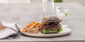 Angel Bay beef burger on plate with fries.